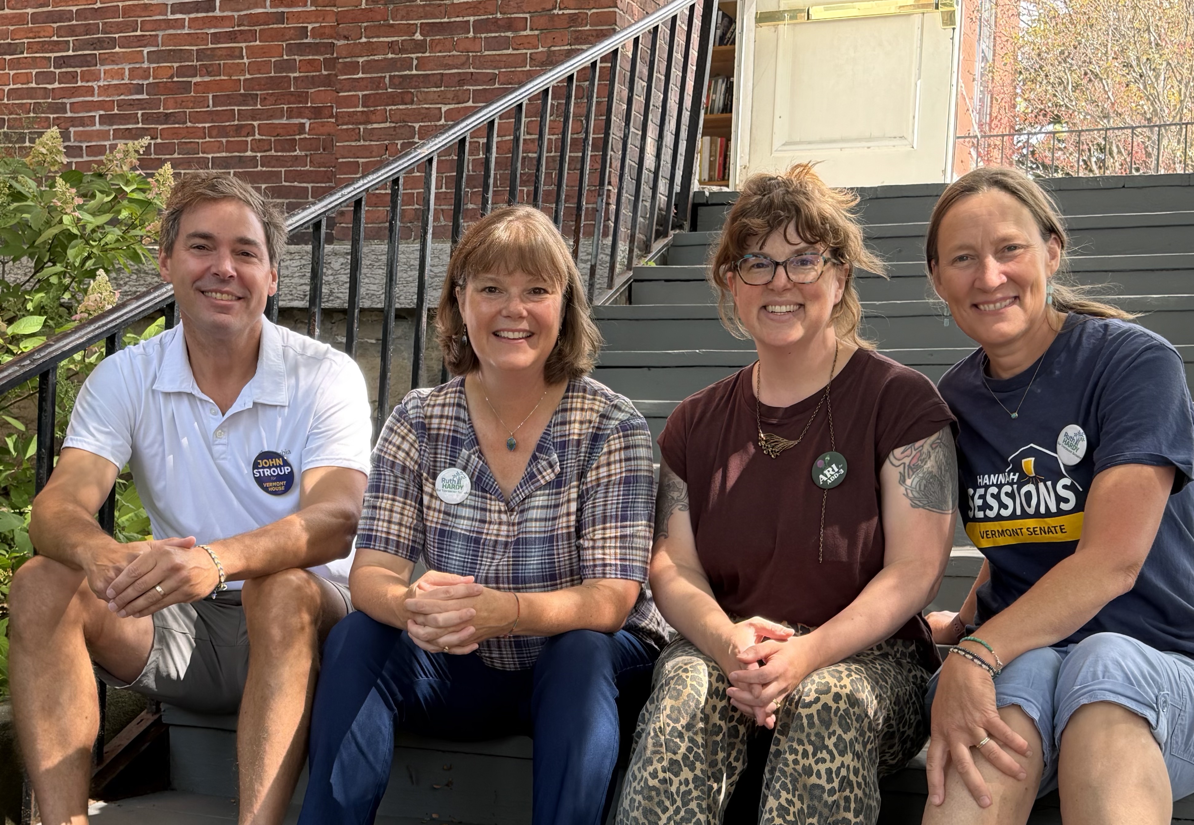 John Stroup with Ruth Hardy, Ariel Bolles, and Hannah Sessions sitting on porch steps